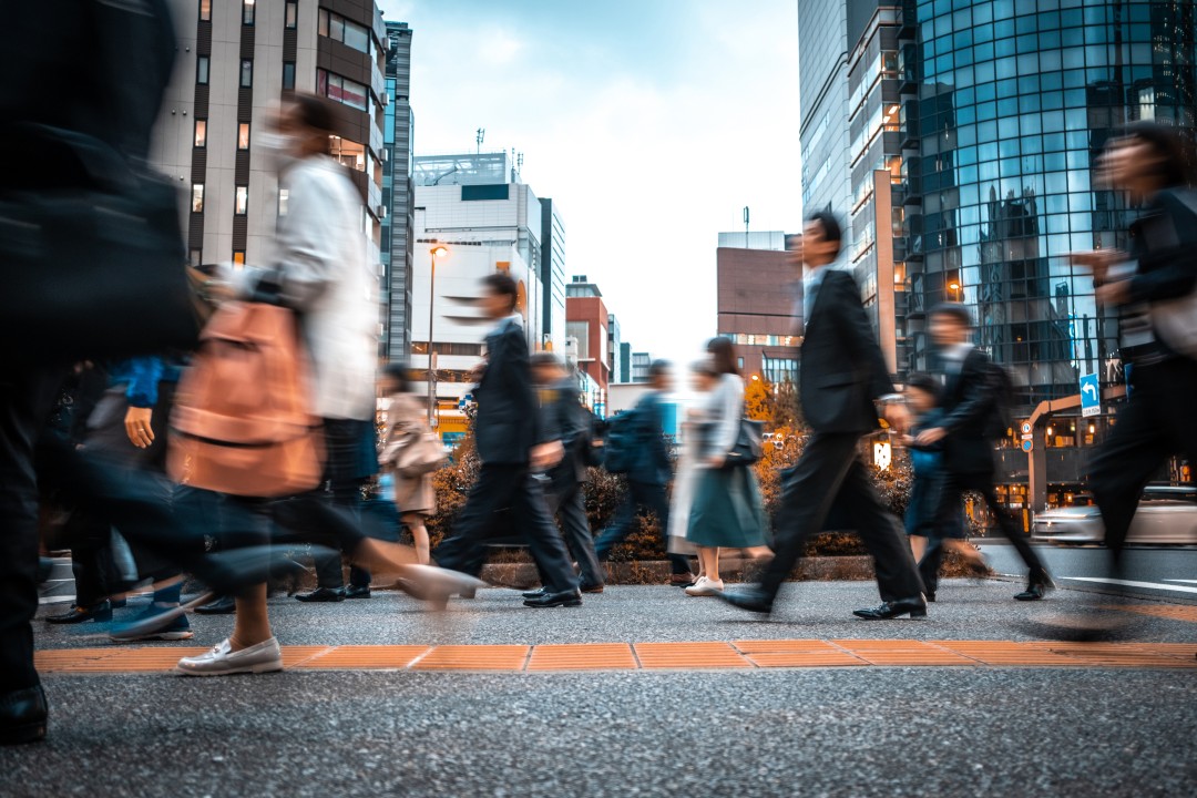 Busy city crosswalk with blurred people walking by